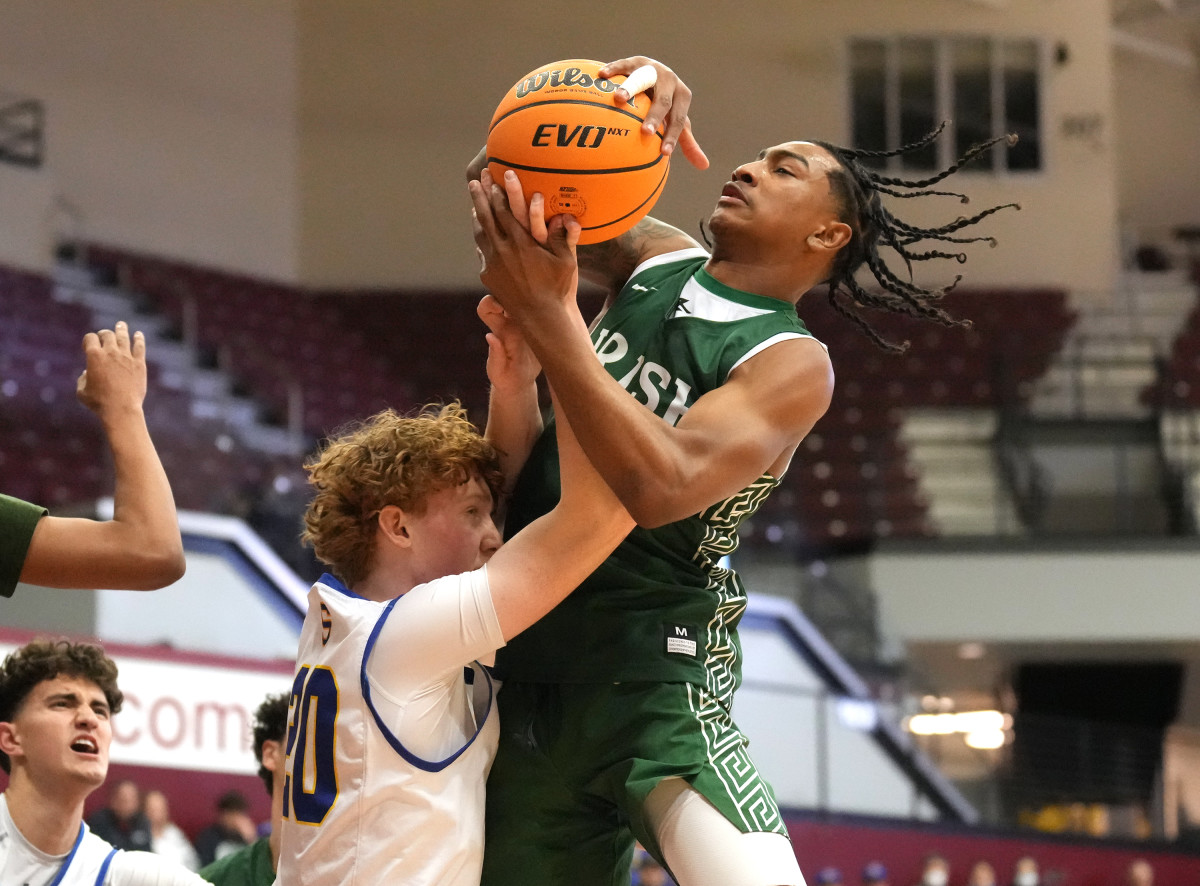 RL Miller grabs a loose ball. Photo: Darren Yamashita. 